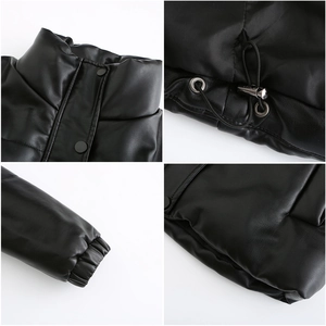 Detail view of black faux leather puffer jacket with drawstring hem and snap buttons