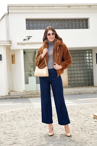 Detail of dark brown plush fleece hoodie jacket with high-waisted wide-leg trousers