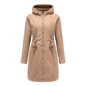 Detail of khaki parka featuring drawstring waist, flap pockets, and plush faux fur hood