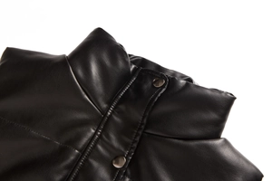 Detail of black PU leather vest showing stand-up collar and silver metal button snap