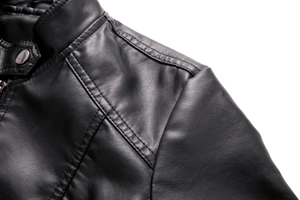 Detail of the stand collar and shoulder stitching on a black faux leather biker jacket