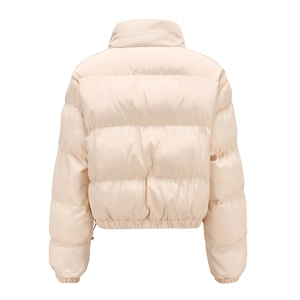 Detail view showing the quilted back and high collar of the beige puffer jacket