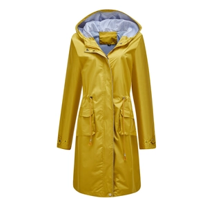Detail of yellow waterproof trench coat featuring blue striped lining and adjustable waist