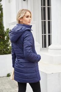 Outdoor shot of a women's navy water-resistant padded parka with a detachable hood