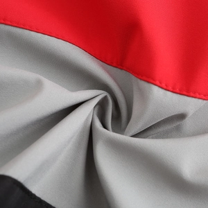 Macro shot of tricolor red, gray and black contrast stitching on waterproof windbreaker fabric