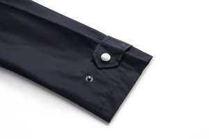 Detailed close-up of jacket cuff with adjustable strap and silver metal snap button
