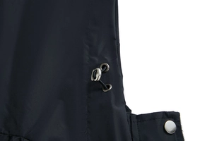 Detail of waterproof black fabric with adjustable elastic drawstring and silver metal hardware