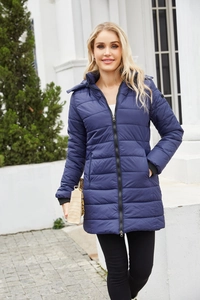 Detail of dark blue quilted coat showing windproof cuffs and hidden zipper pockets