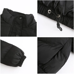 Detail view of winter padded jacket showing high collar, drawstring hem and elastic cuffs