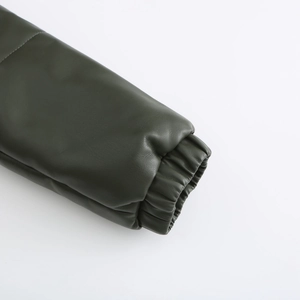 Close-up of elastic windproof cuffs on dark green faux leather puffer jacket