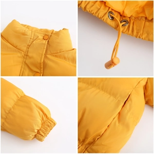 Detail view of yellow puffer jacket featuring drawstring toggles and elastic cuffs