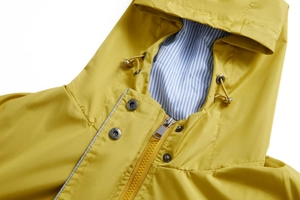 Detail of yellow waterproof parka with blue striped lining and drawstring hood