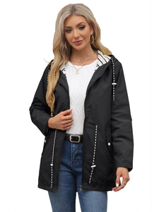 Detail of waterproof black parka featuring adjustable drawstring waist and striped hood lining