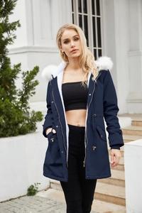 Detail of dark blue parka with white faux fur lining and adjustable drawstring waist