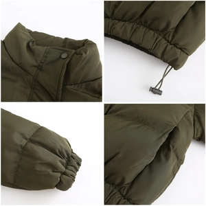 Detail view of olive green quilted jacket featuring snap collar and drawstring hem