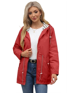 Detail of red hooded windbreaker featuring striped lining and adjustable drawstrings