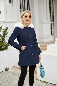 Detail of navy parka coat with white faux fur hood and drawstring waist detail