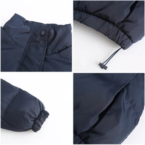 Detail view of navy blue puffer jacket showing windproof stand collar and elastic cuffs