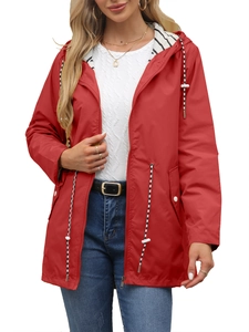 Detail of red waterproof raincoat featuring striped lining and drawstring hood detail