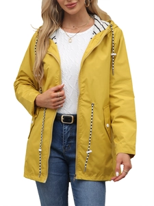 Detail of yellow hooded raincoat featuring striped lining and black-white drawstring accents