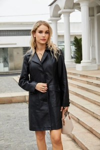 Detailed view of the lapel and black button closure on a women long leather coat