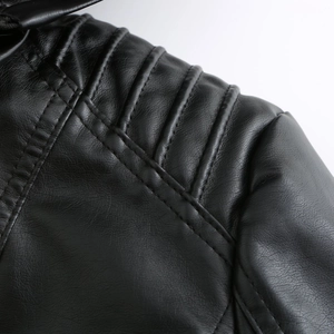 Close-up of quilted shoulder stitching on black leather jacket with zipper hood