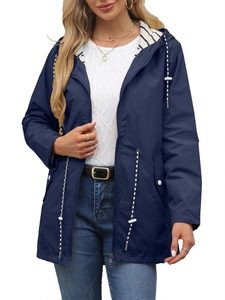 Detail of waterproof navy raincoat featuring a stylish striped lining and drawstrings