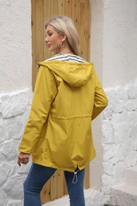 Detail of yellow waterproof raincoat with striped lining and adjustable waist drawstring