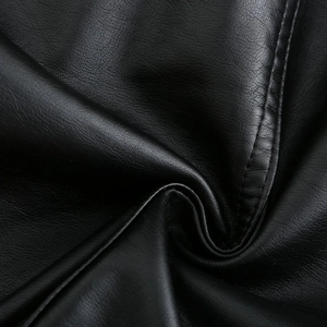 Close-up of black leather texture with fine stitching details on the hooded jacket