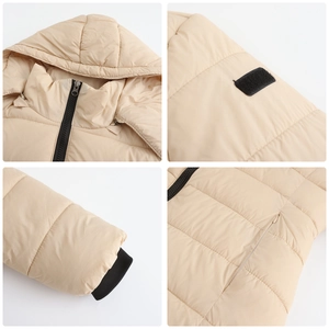 Detail view of beige winter parka with detachable hood, velcro cuffs, and quilted texture