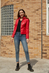Outdoor shot of a woman in a red faux leather biker jacket with black platform boots