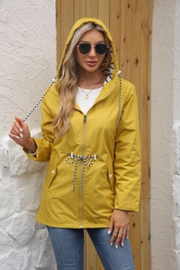 Detail of yellow waterproof raincoat with striped hood lining and adjustable drawstring