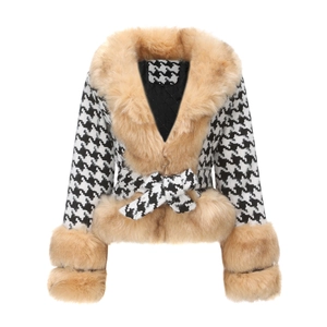 Detailed view of women's houndstooth coat with faux fur collar and quilted lining