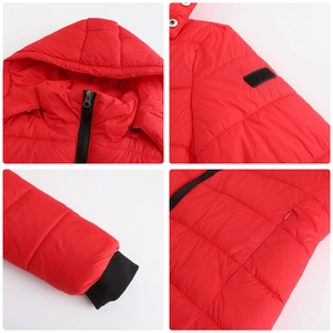 Detail view of red quilted puffer jacket featuring windproof cuffs and secure zip pockets