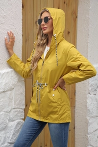 Detail of yellow hooded trench coat with adjustable waist drawstrings and side flap pockets