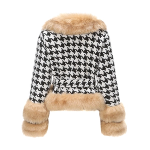 Detailed view of black and white houndstooth fabric with plush faux fur cuffs and hem
