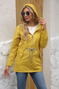 Detail of yellow hooded raincoat featuring striped lining and adjustable drawstring waist