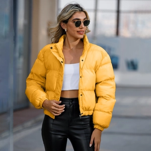 Women's short yellow puffer jacket with high collar and quilted design for winter