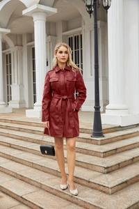 Dettaglio cappotto bordeaux in pelle PU con texture raffinata, risvolto e cintura in vita