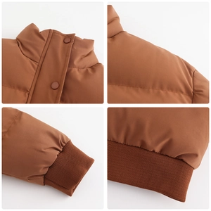 Detail view of caramel brown puffer jacket showing stand collar and elastic ribbed cuffs