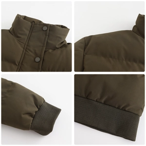 Detail of army green quilted puffer jacket featuring ribbed cuffs and metal snap buttons