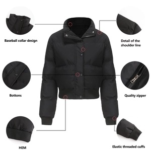 Detail view of black puffer jacket showing zipper, elastic cuffs and metal buttons