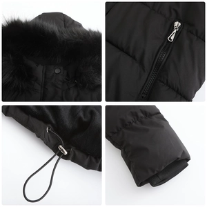 Detail view of winter coat with faux fur collar, metal zipper, and ribbed cuffs