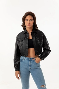 Detailed view of women's black faux leather jacket with lapels and button pockets
