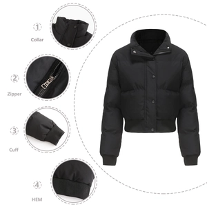 Detail view of high collar, zipper closure, and ribbed cuffs on black puffer jacket