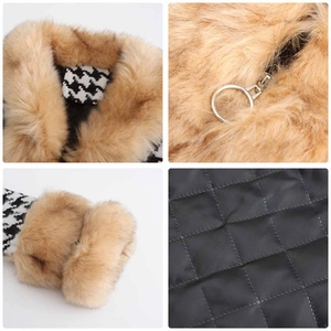 Detail view of houndstooth jacket featuring faux fur collar and silver ring zipper pull