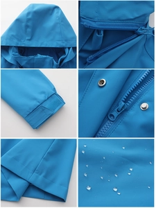 Detail view of blue waterproof jacket with hood, zipper, adjustable cuffs and water beads