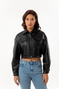 Close-up of the black leather jacket featuring a classic collar and flap chest pockets