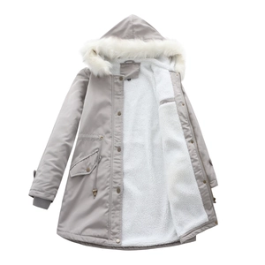 Macro shot of fluffy faux fur collar and warm white fleece lining on gray hooded parka