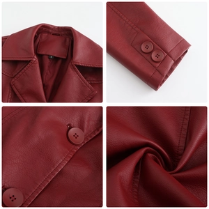 Detail view of dark red PU leather trench coat features lapels and buttons on cuffs